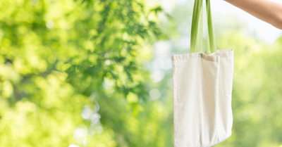 reusable shopping bag with summery green leaves in background