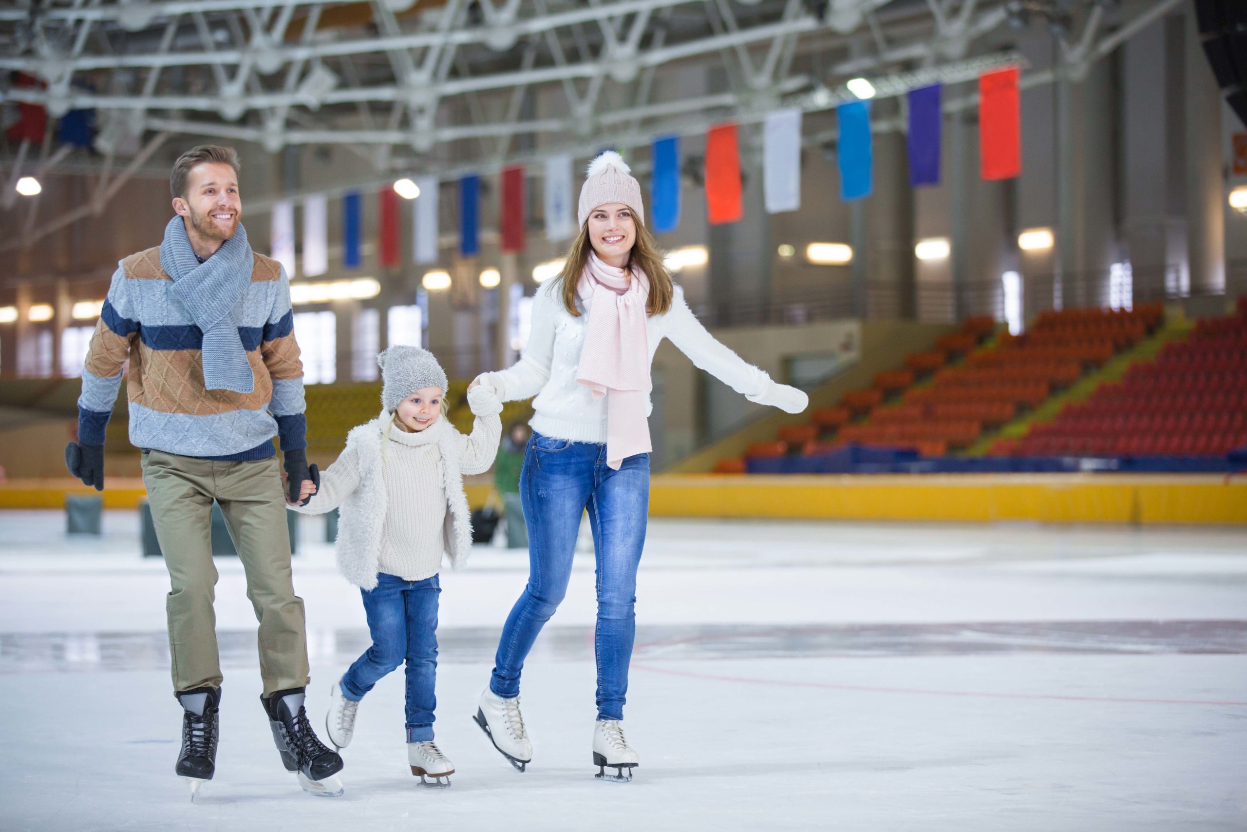 Family skating on indoor ice rink