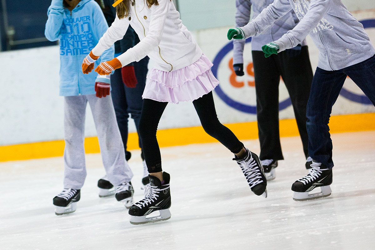 Children skates on ice rink