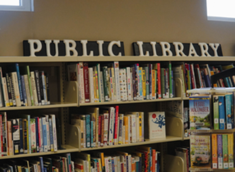 book shelves with words on blocks on top shelf that say PUBLIC LIBRARY