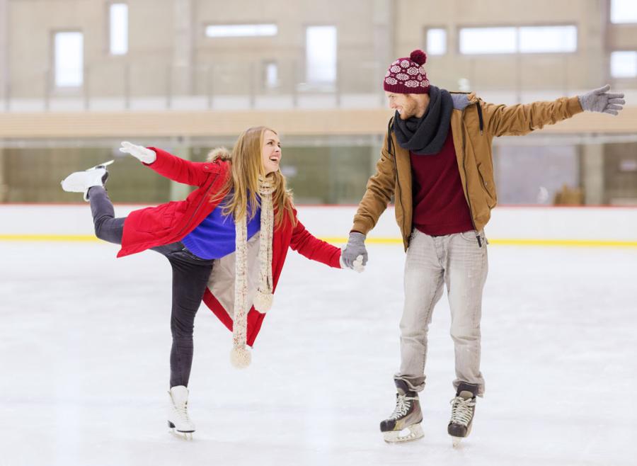 Couple skating on an indoor ice rink