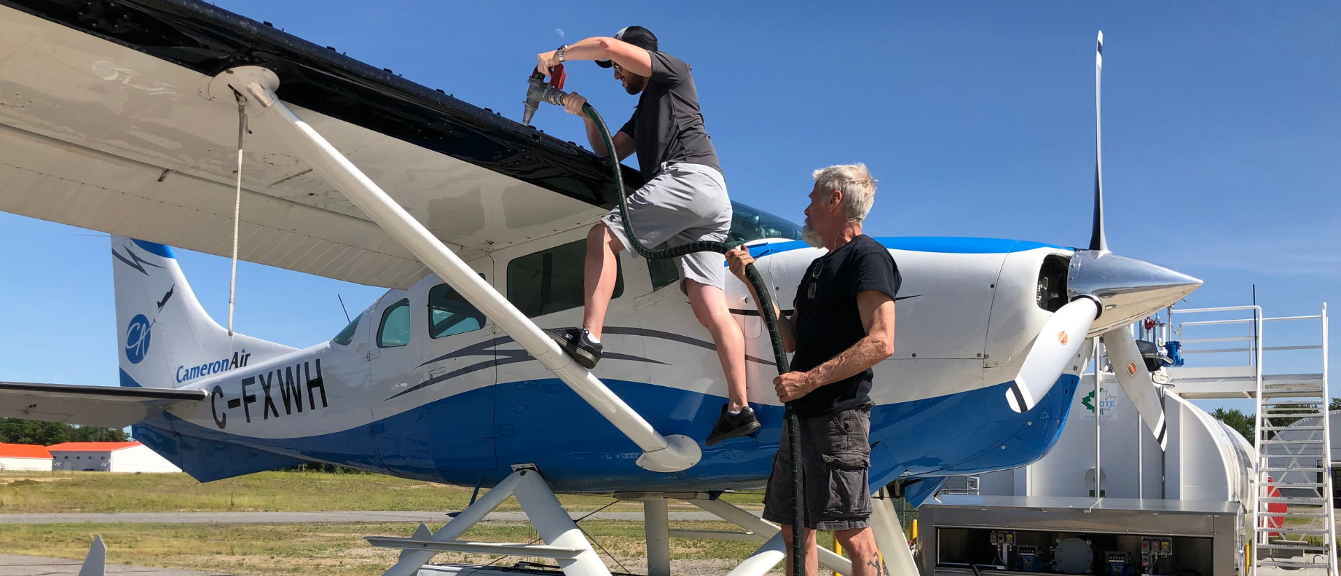 Two men fueling a plane