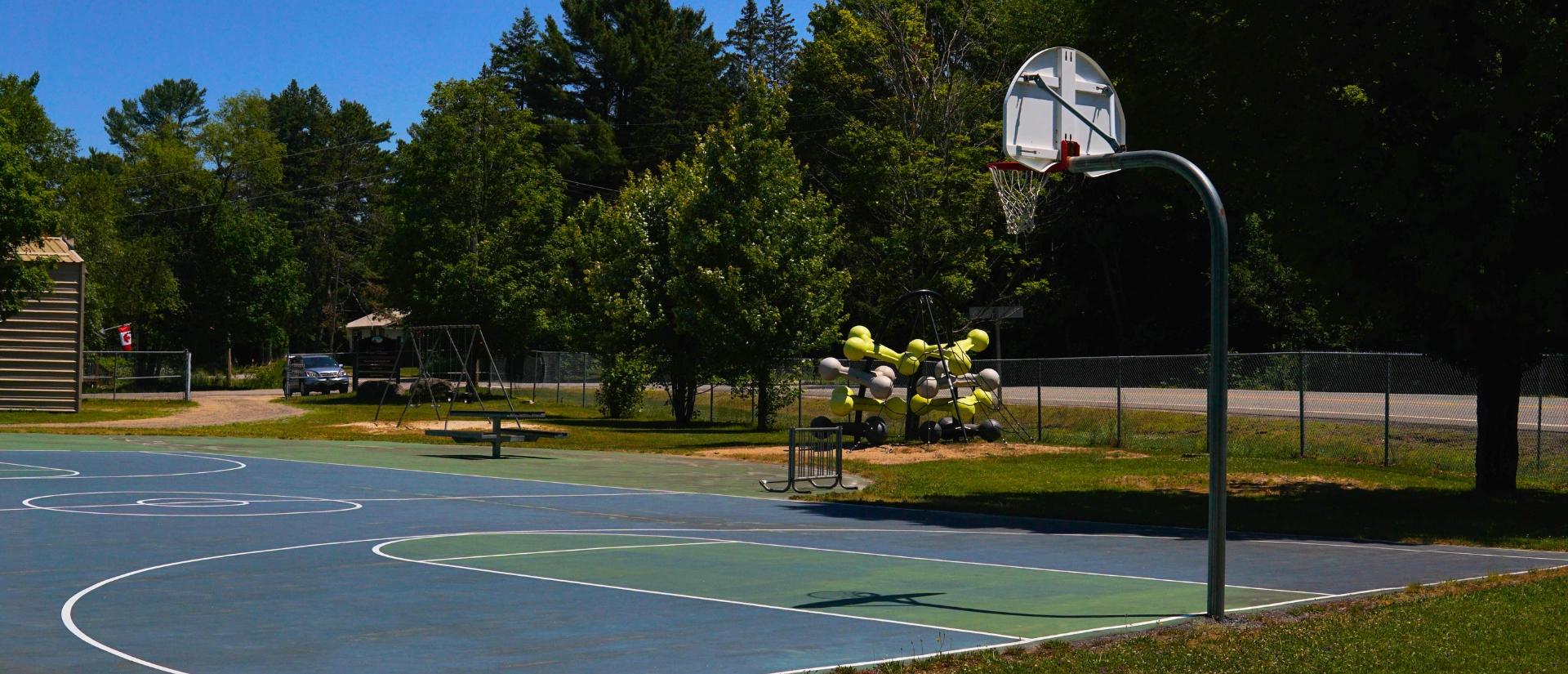 Basketball court with a playground in the distance