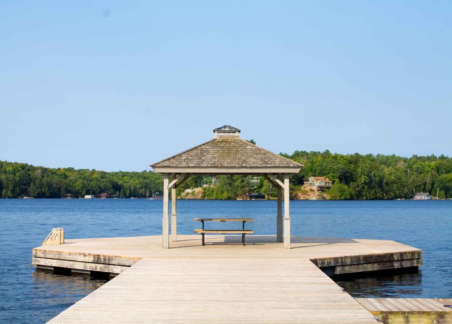 Image of wooden pavilion on lakeside dock with picnic bench