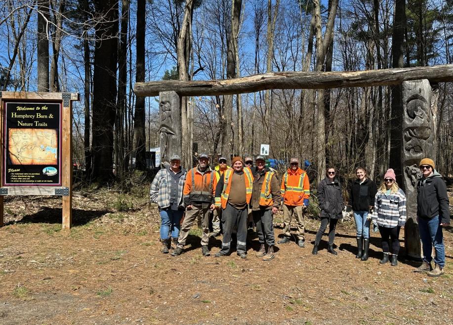 Group of volunteers standing at entrance to hiking trail