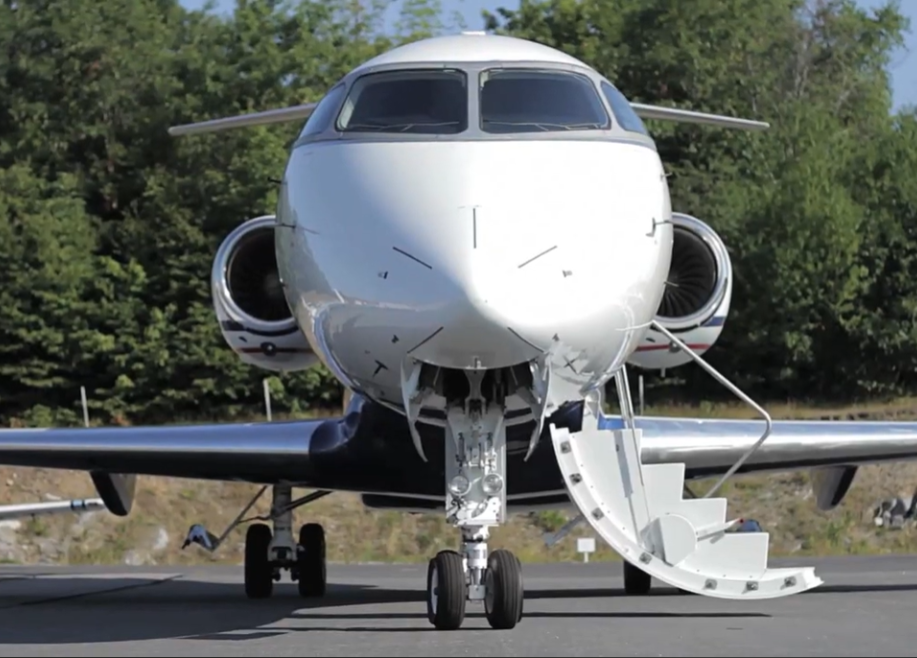 Front facing view of a passenger airplane with its stairs extended down