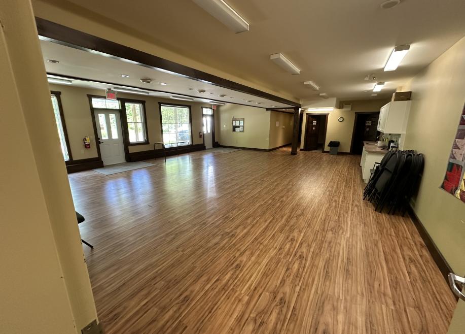 side view of room with a sink and fridge on one side